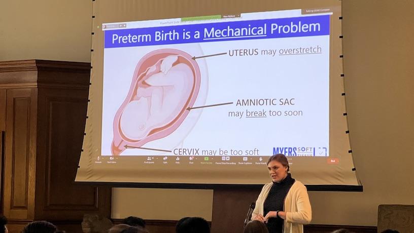 Erin Louwagie presenting. The screen behind her reads "Preterm Birth is a Mechanical Problem"