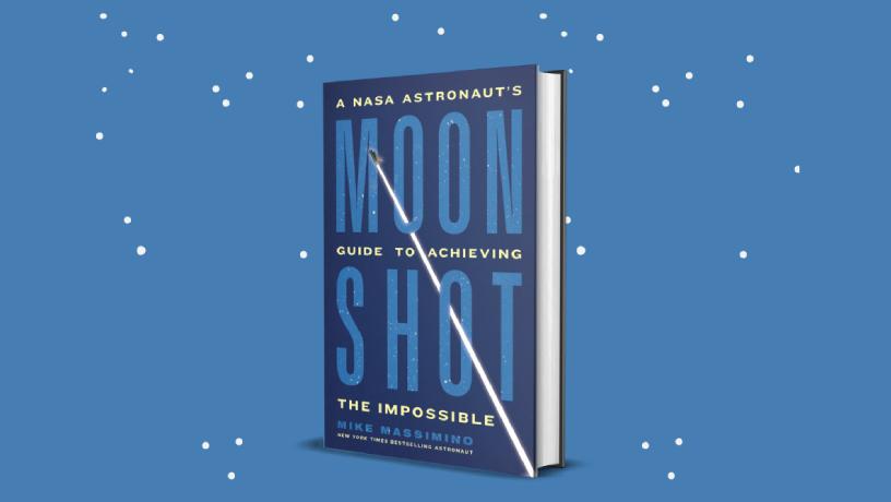 Mike Massimino's book standing upright. The cover reads "Moon Shot. A NASA Astronaut's Guide to Achieving the Impossible. Mike Massimino. New York Times Bestselling Astronaut." 